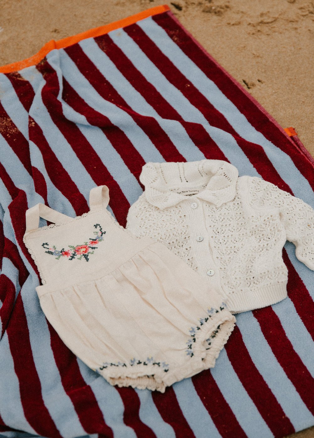 Crafted from soft cotton fabric, this romper features fine, delicate embroidery details on the front and hem.