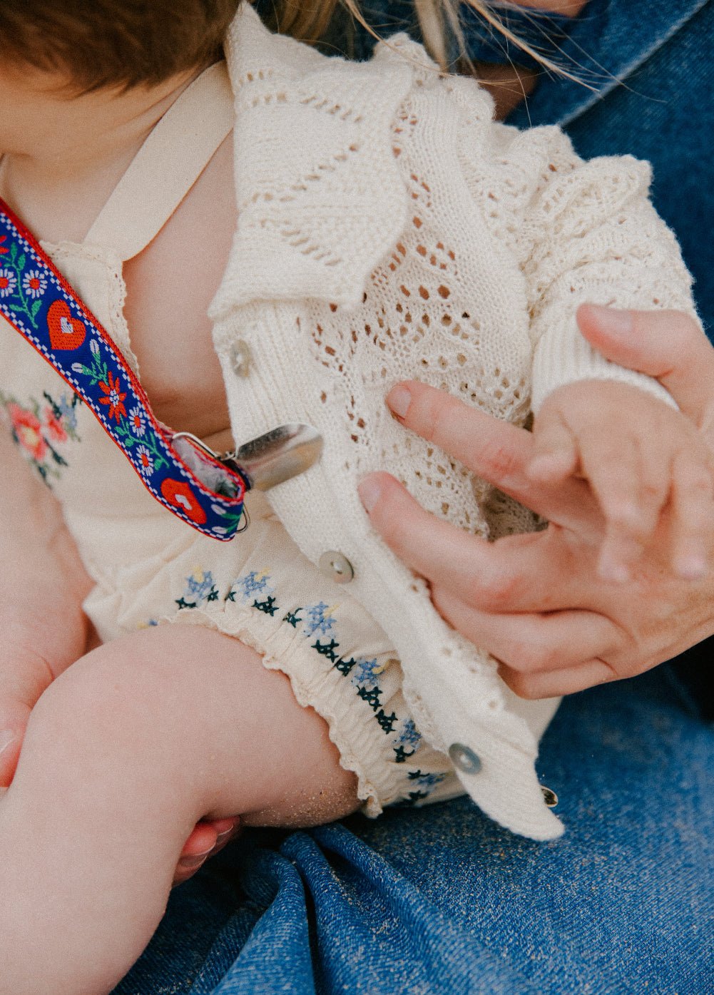 Crafted from soft cotton fabric, this romper features fine, delicate embroidery details on the front and hem.