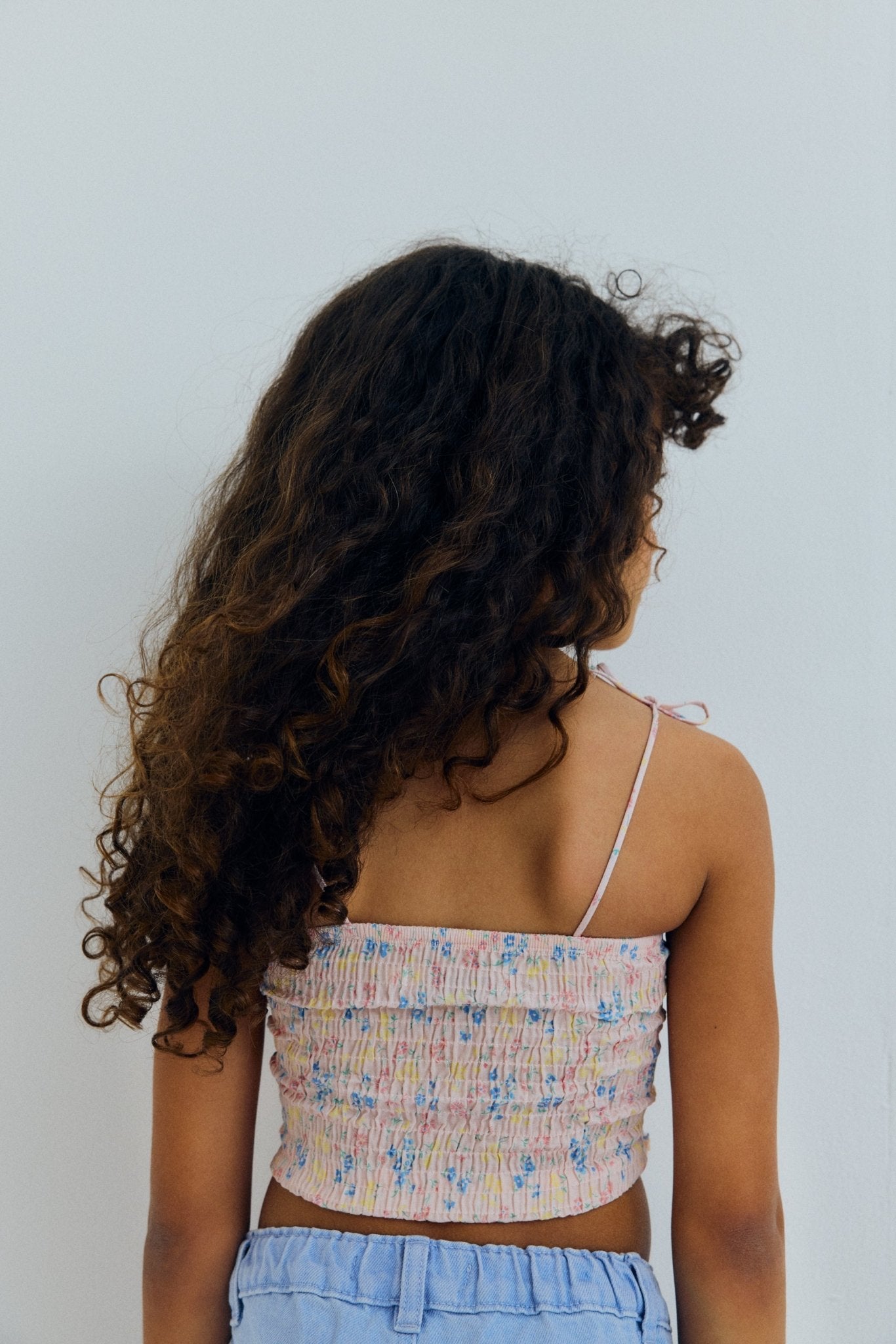 Oberteil aus Bio-Baumwolle mit gesmoktem Oberteil für eine bequeme, flexible Passform und zartem Rüschensaum, der für Bewegung und Charme sorgt. 