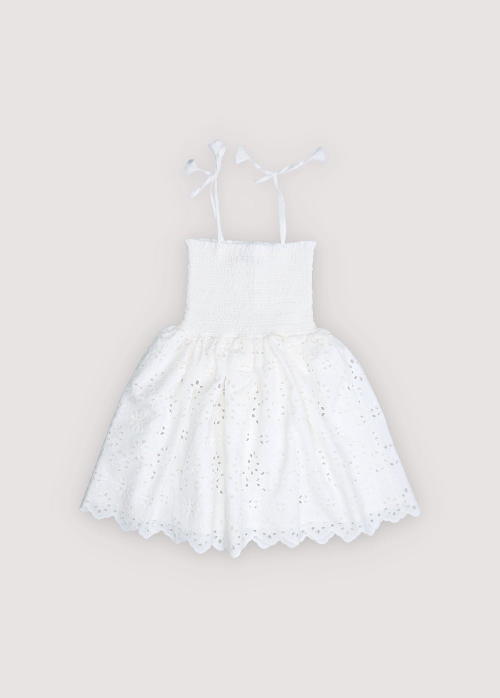 Short dress in beautiful embroidered cotton fabric, featuring a smocked bodice with ruffle detail for a comfortable and flattering fit.