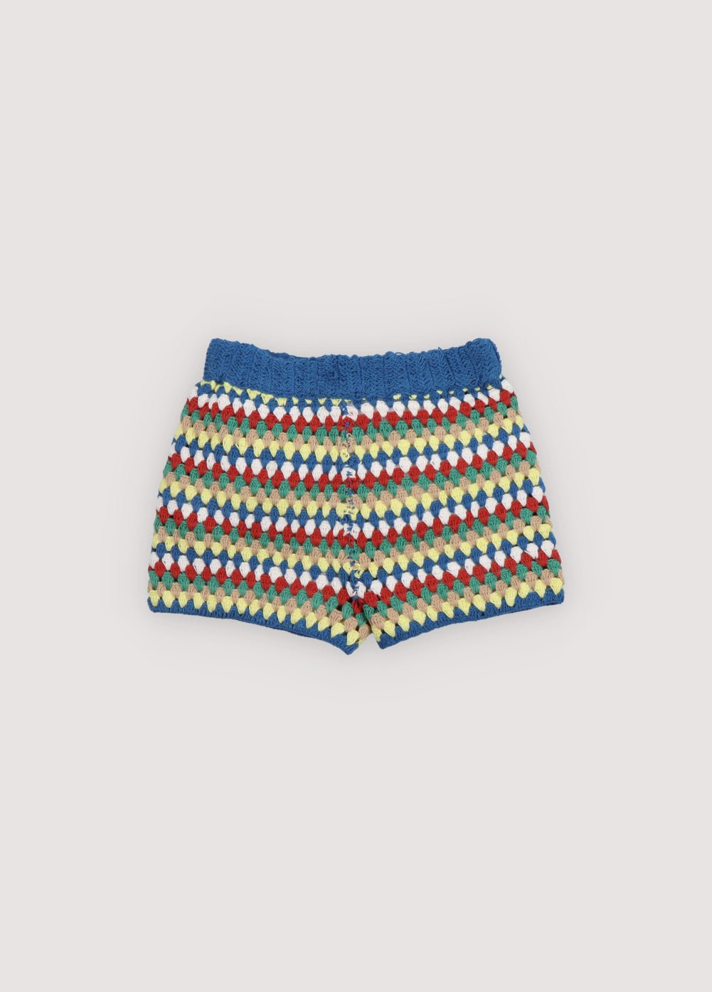 Crochet shorts with colorful stripes and ribbed elastic waistband. It comes with a jumper and a bucket hat to create a total look. Spring Summer Collection. The New Society. 