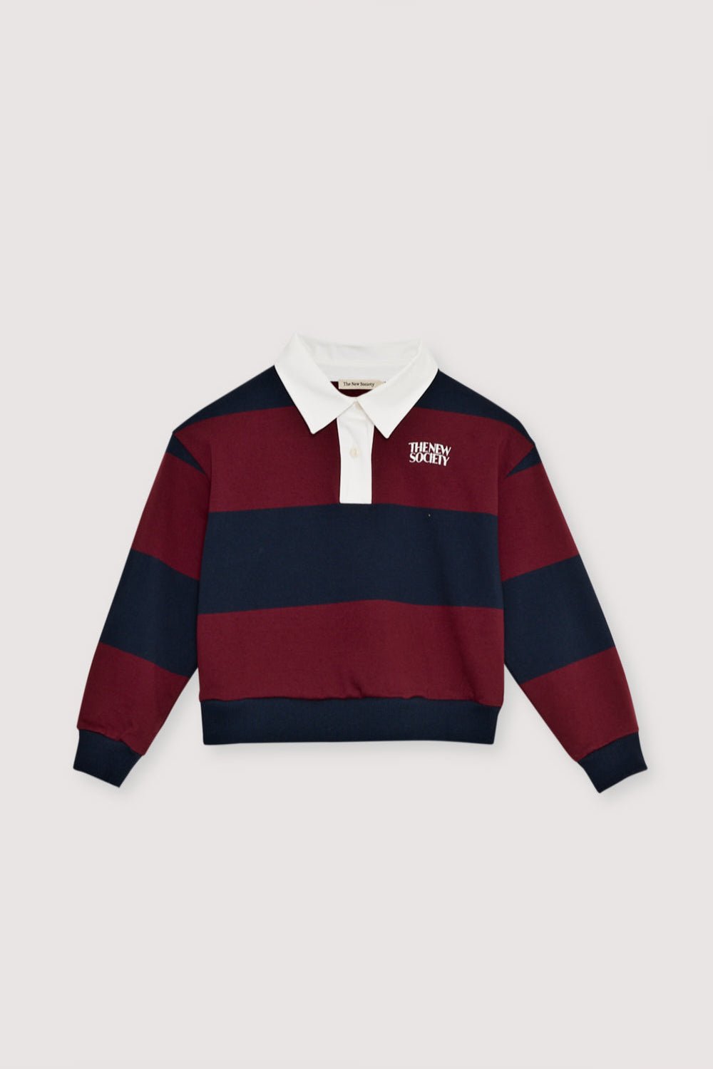 Bicolor striped crop polo with a contrasting collar in twill fabric. It features a contrasting print on the chest.