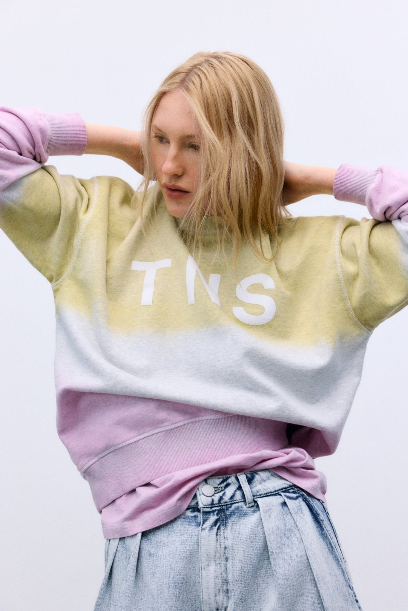 Crafted from soft melange cotton, this sweatshirt features a stylish two-tone tie-dye effect and a subtle TNS print on the front.
