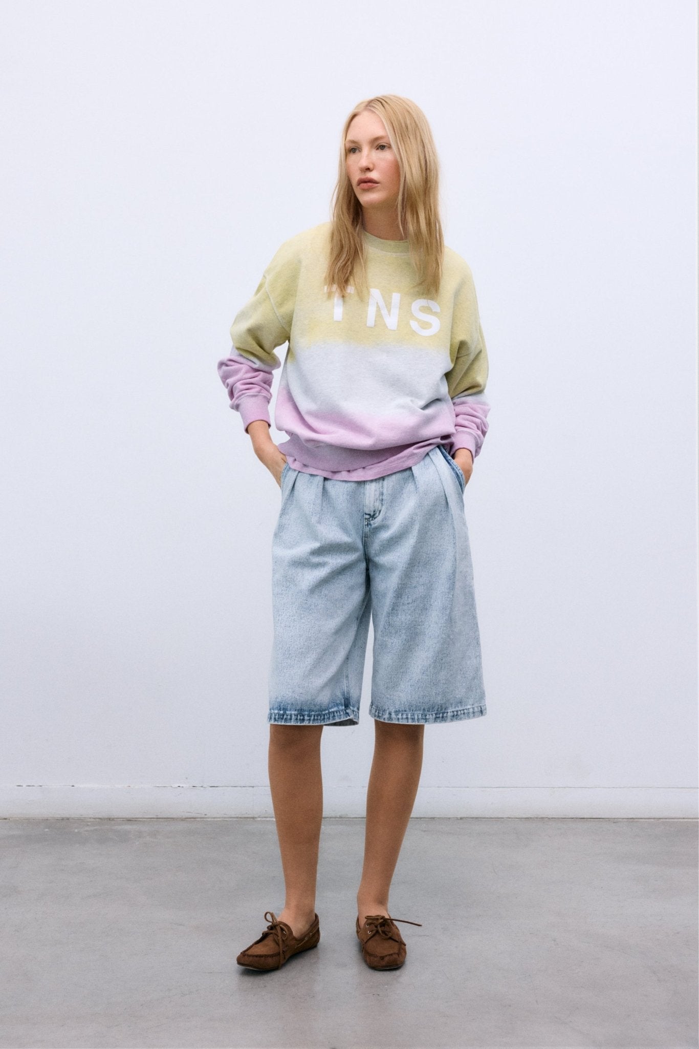 Crafted from soft melange cotton, this sweatshirt features a stylish two-tone tie-dye effect and a subtle TNS print on the front.
