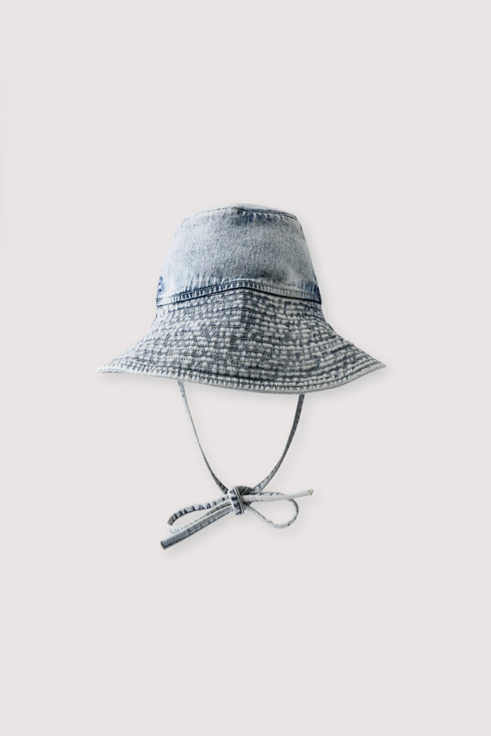 Bleach-wash denim bucket hat designed with a wide brim for a relaxed yet contemporary look.