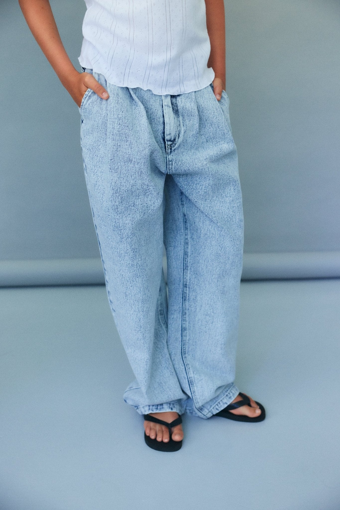 Teen denim trousers crafted from bleach-washed cotton using our signature pinched denim pattern.