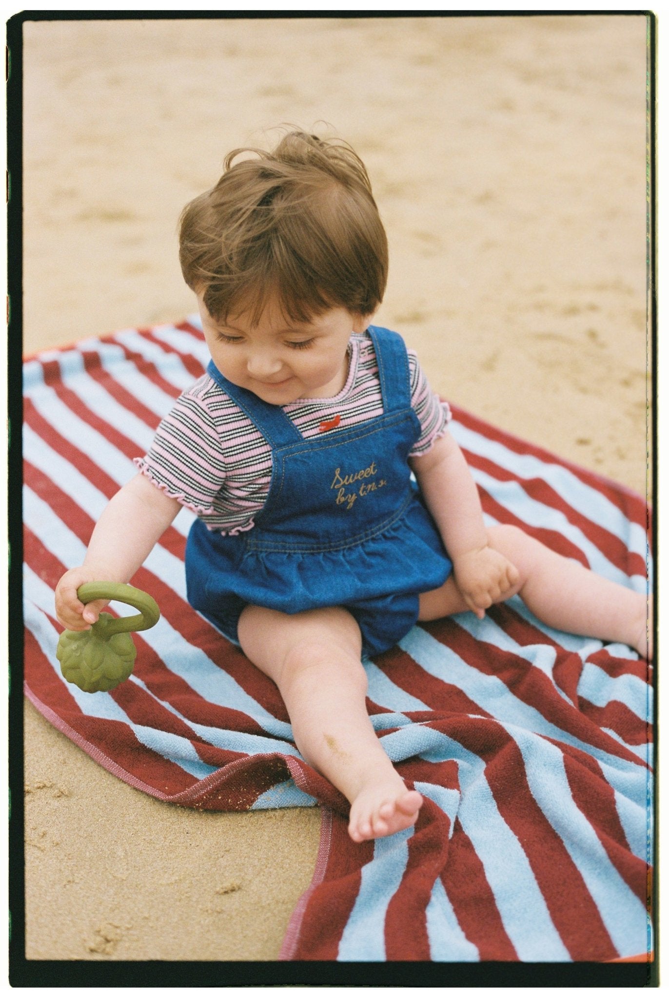 Baby romper crafted from 100% cotton denim.