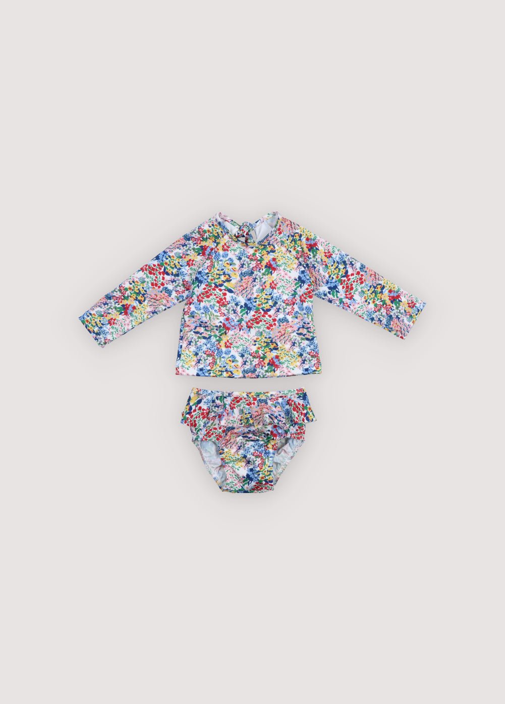 Two piece&nbsp;long sleeve swimsuit featuring a beautiful floral print, a back cutout, and a tie closure for a secure and stylish fit.